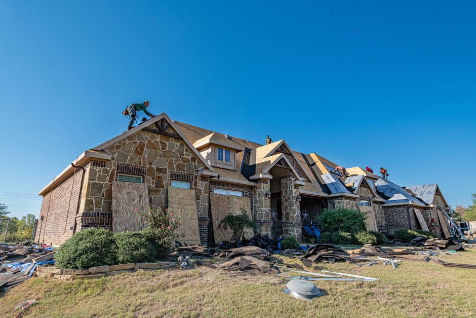 Professional roofing contractor working on exterior home improvement